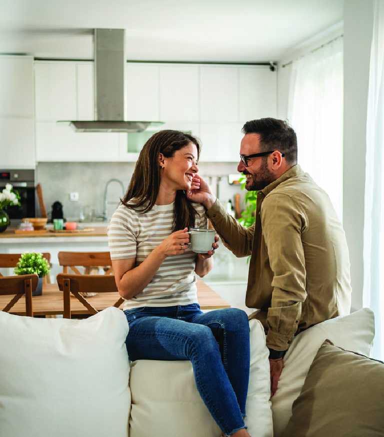 A couple with coffee in their kitchen