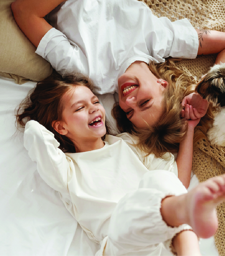 Two children lying down laughing