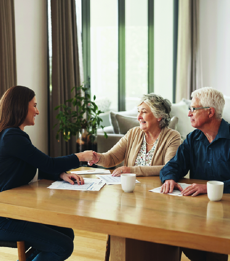 An older couple meeting with an adviser
