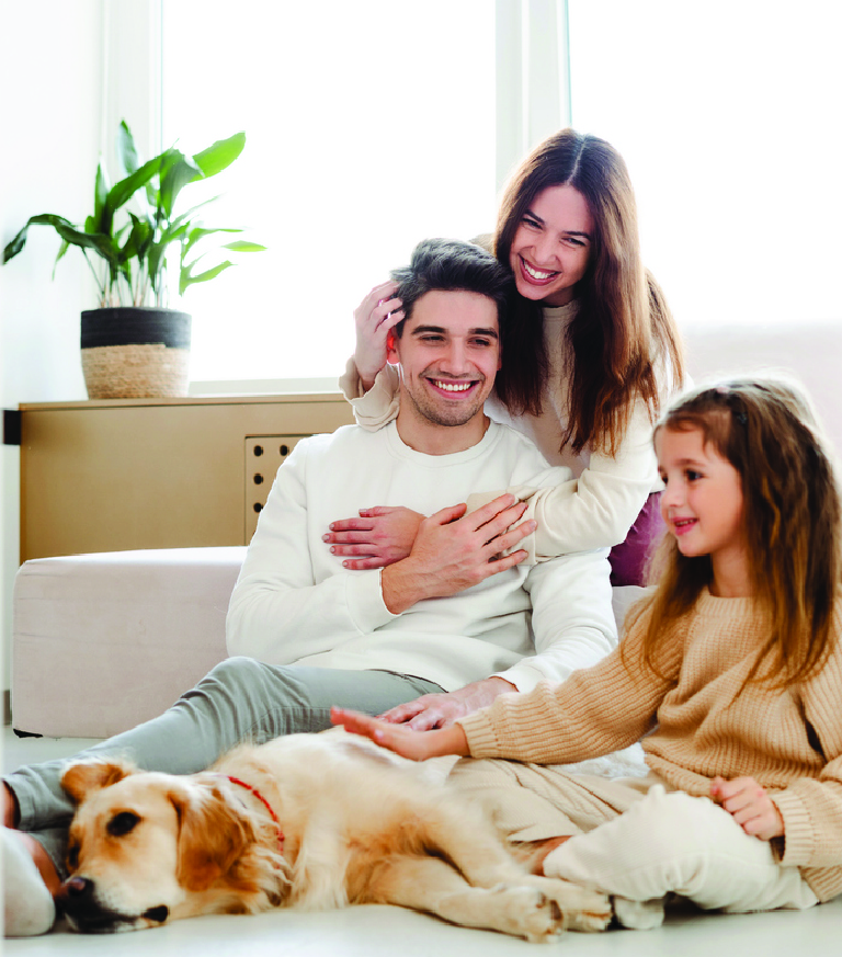 A family with their dog on the sofa