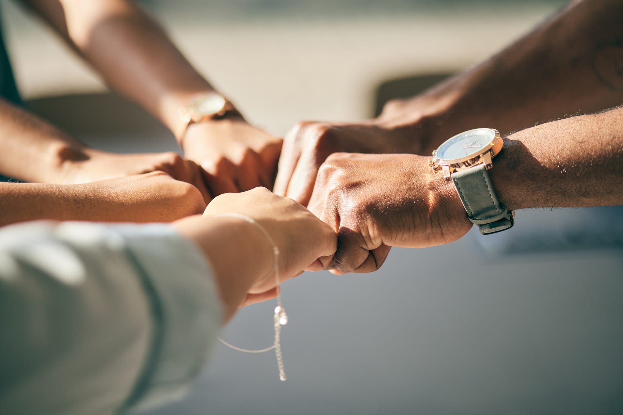 A group of people joining hands