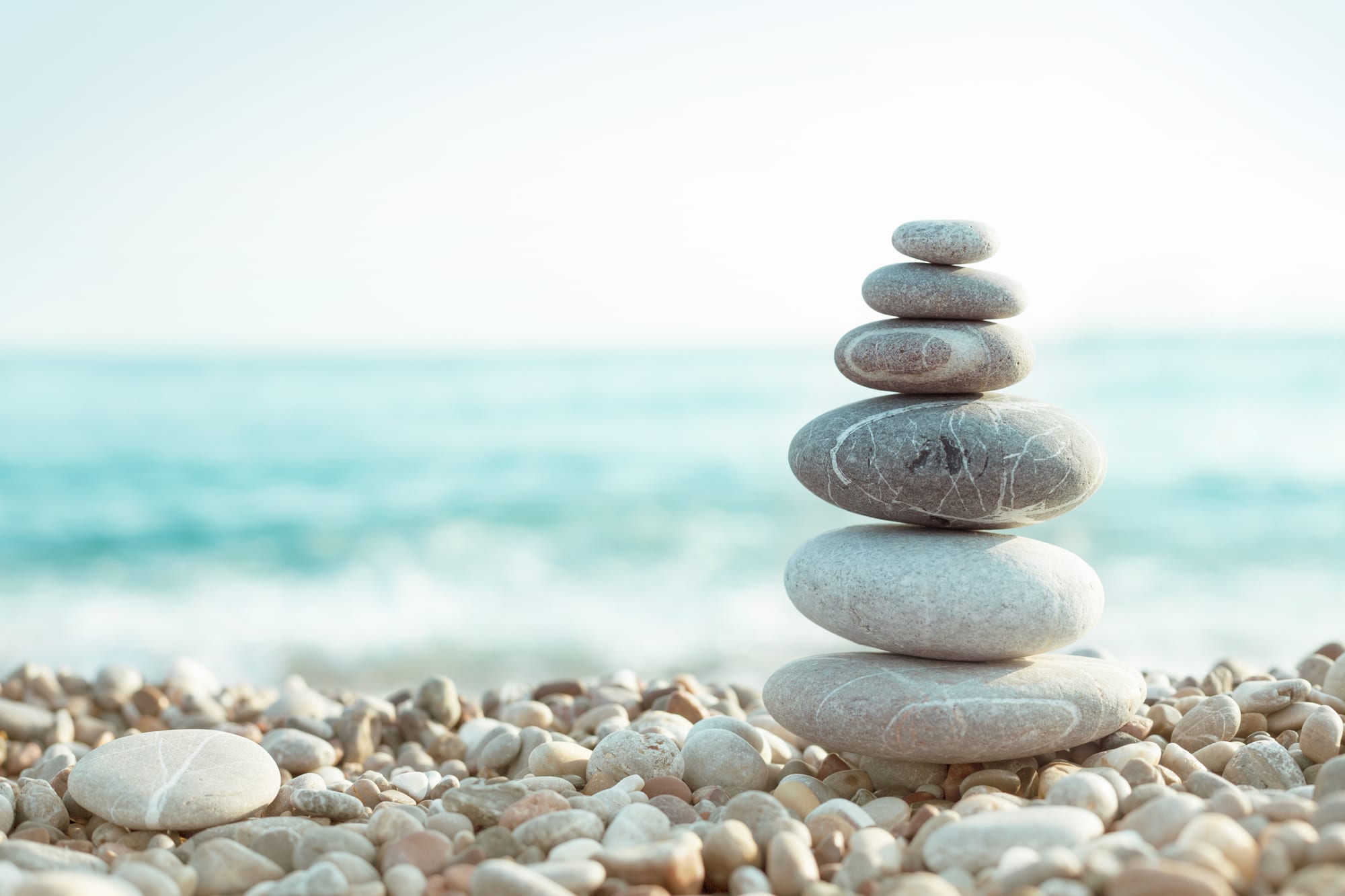 Balanced stacked stones on a beach
