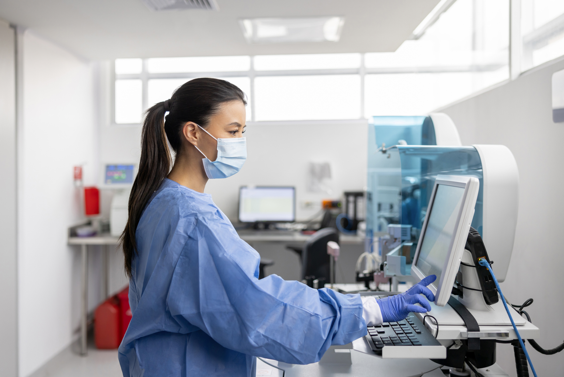 A sonographer operating an ultrasound machine